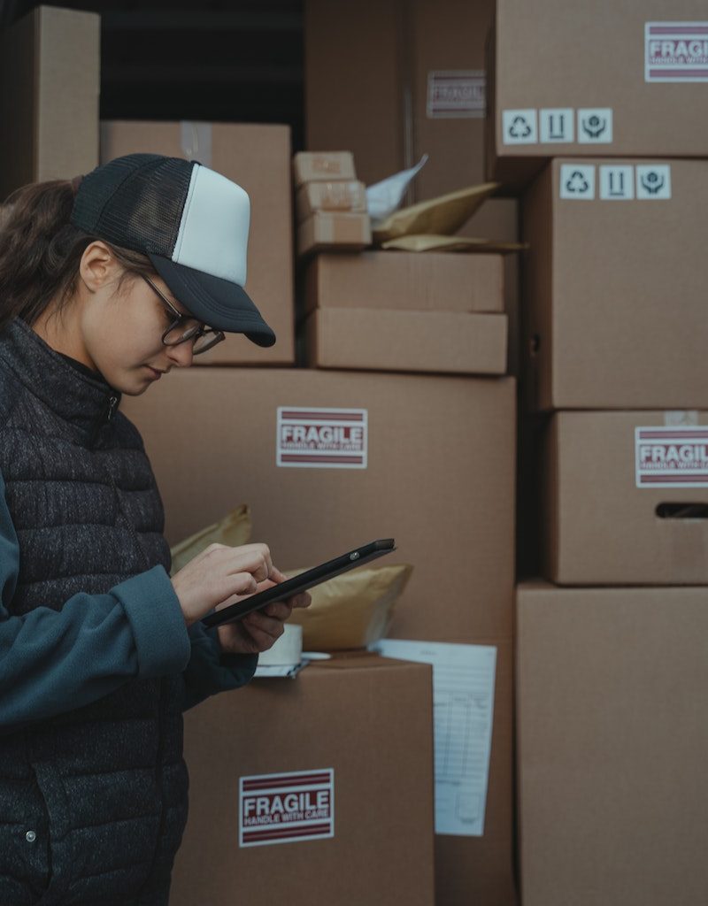 Woman in Black Jacket Holding Black Tablet Computer